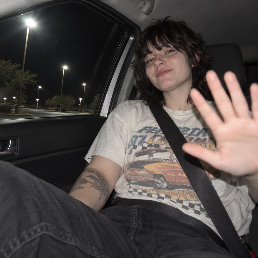 Car-Seat Point-and-Shoot: A lively flash photo taken from low near the glove compartment, looking up at one person in the front passenger seat.