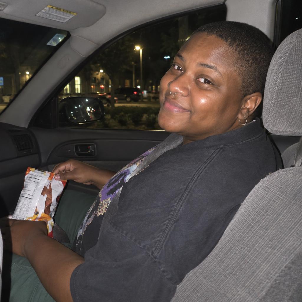 Car-Seat Point-and-Shoot: A spontaneous vertical point-and-shoot photo taken from the back seat toward the front passenger seat.