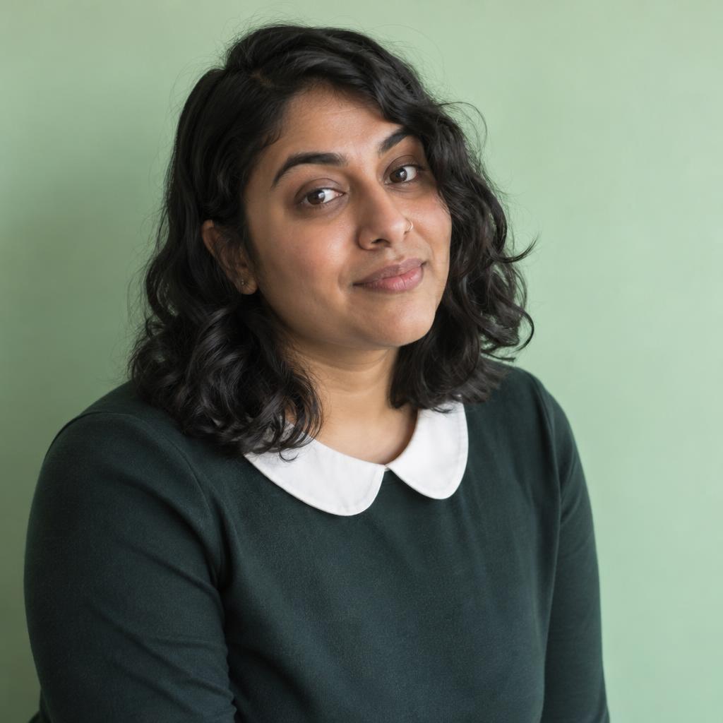 Quirky Comedy Casting Look: Photographic acting headshot against a plain mint-green wall.