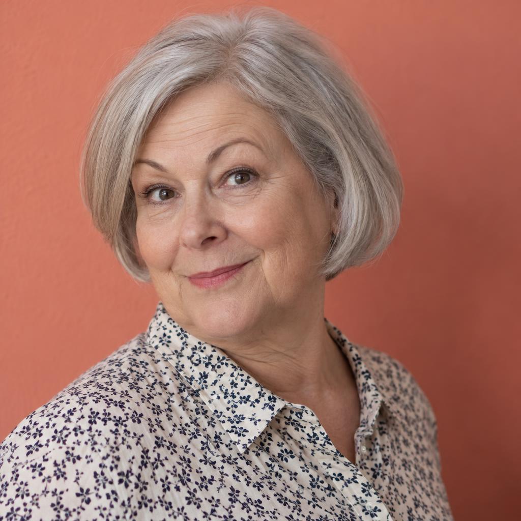 Quirky Comedy Casting Look: Photographic acting headshot from the shoulders up against a smooth coral wall.