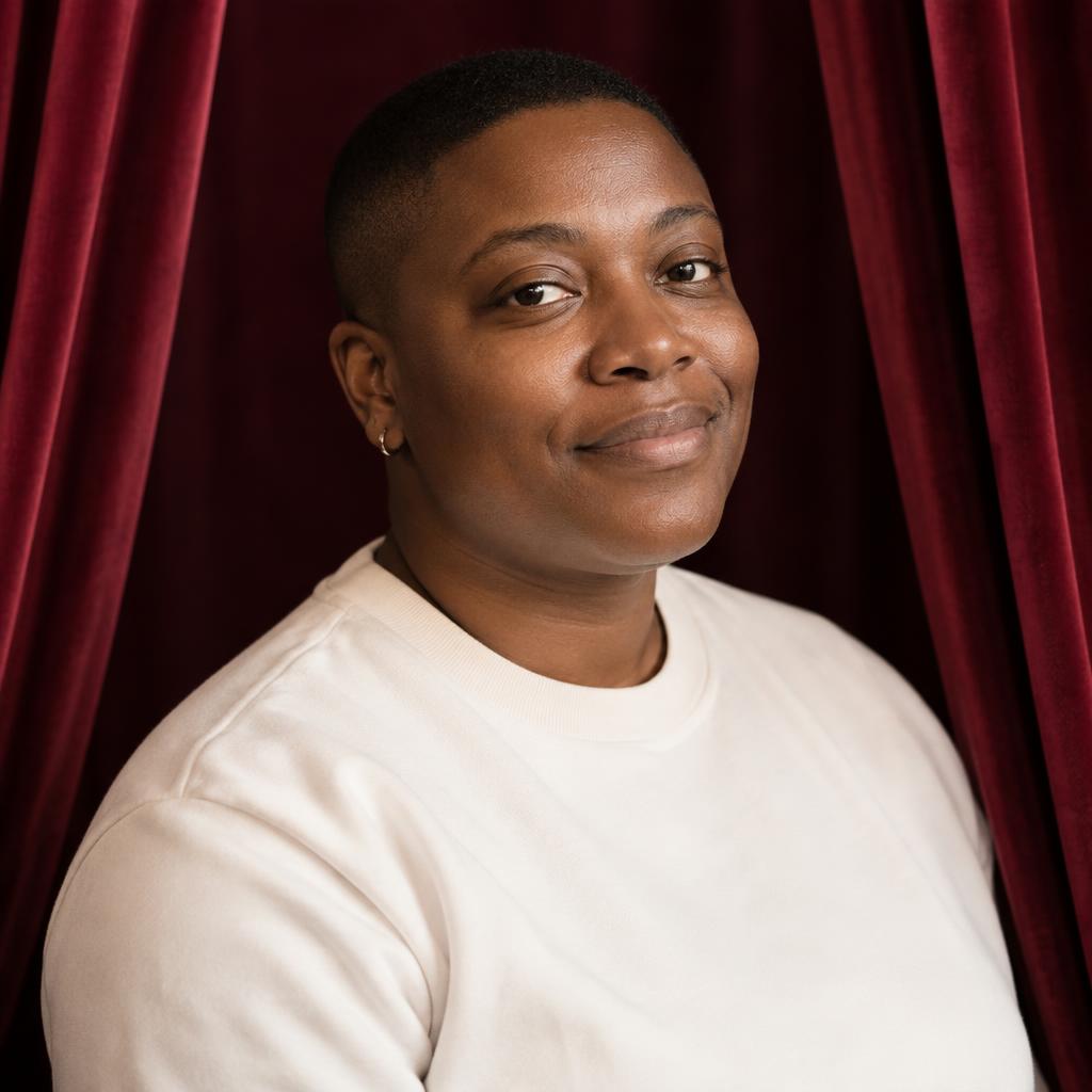 Musical-Theater Presence: Photorealistic chest-up portrait framed between softly gathered wine-colored stage drapes.
