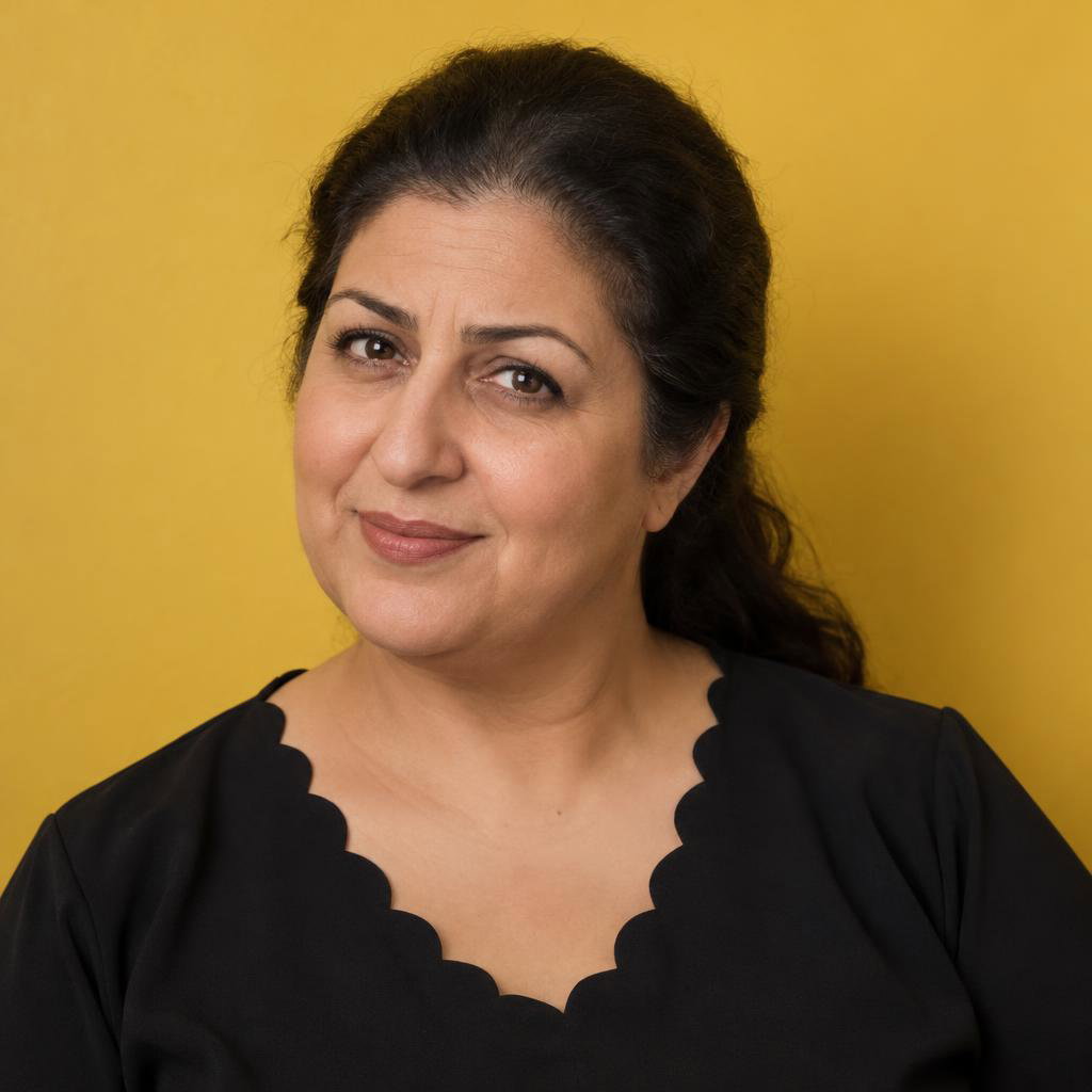 Quirky Comedy Casting Look: Photographic acting headshot against a solid golden-yellow wall, cropped at mid-chest.