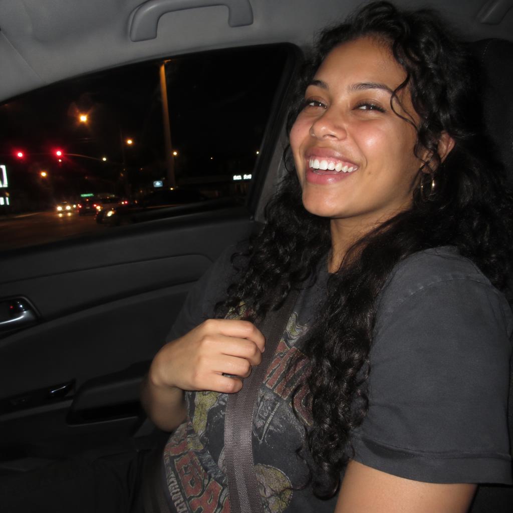 Car-Seat Point-and-Shoot: A candid 2016 point-and-shoot photo from the center console: one person laughing in the front passenger seat, one hand resting on the seat…